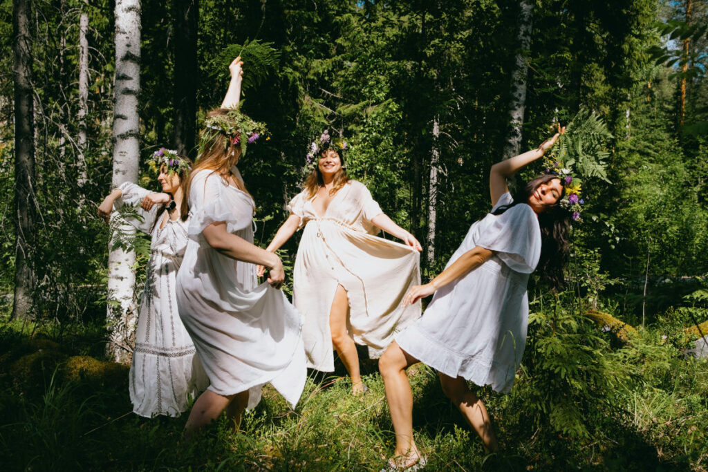 Dancing people wearing crown during Swedish Midsummer celebration
