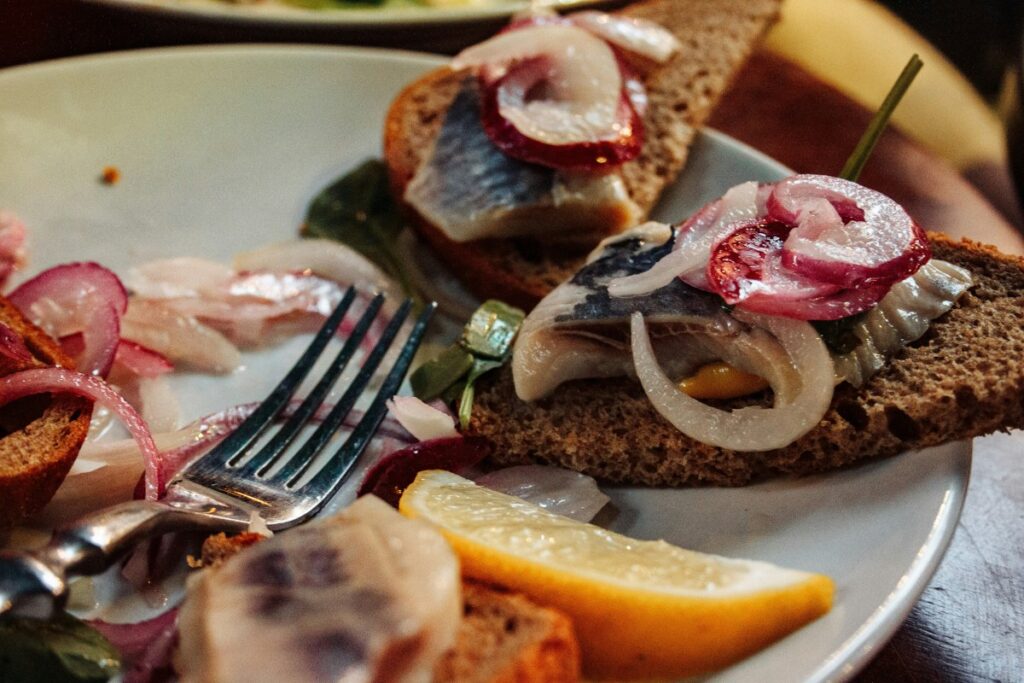 Traditional Swedish Midsommar table with pickled herring new potatoes and strawberries